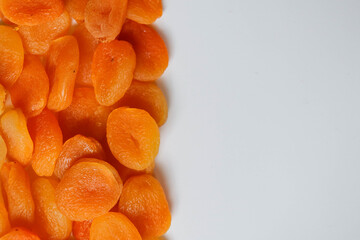 Dry apricots placed on a white board. Place for text 