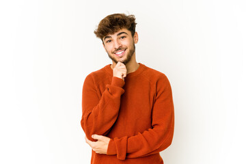 Fototapeta na wymiar Young arab man on white background smiling happy and confident, touching chin with hand.