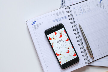 Diary and notebook for Planner. Calendar, smartphone place on white desk. 