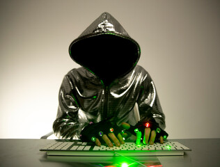 Computer hacker in silver jacket