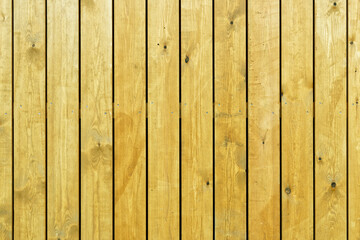 Plank yellow wall. The boards are nailed down.