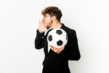 Young indian soccer coach isolated shouting and holding palm near opened mouth.
