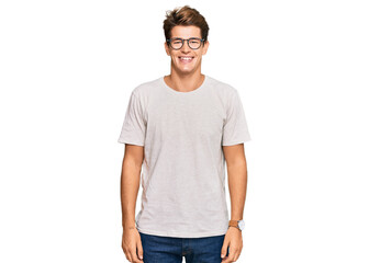 Handsome caucasian man wearing casual clothes and glasses with a happy and cool smile on face. lucky person.