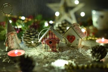 New Year's composition - a small houses, a candlestick, cones, a candle, garlands, a star.