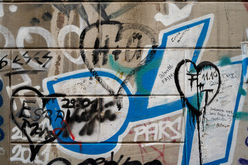 Turkey, Istanbul, December 2020: urban street graffiti on the wall with torn grunge textures with copy space background.