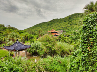 Fototapeta na wymiar View of the pagoda, pavilion and palm tops. Nanshan Cultural Tourism Zone. Sanya. Hainan Island. China. Asia