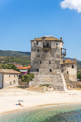 Beach fortress in Ouranoupoli with a single lonely sole lady women sunbathing on the beach nearby  