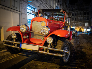 Red old vintage classic car on the night street