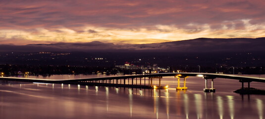 Long duration exposure of the sunrise breaking over the tops of nearby mountains, and leaving a...