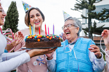 hispanic women Family Celebrating a grandmother happy Birthday with cake in Mexico city