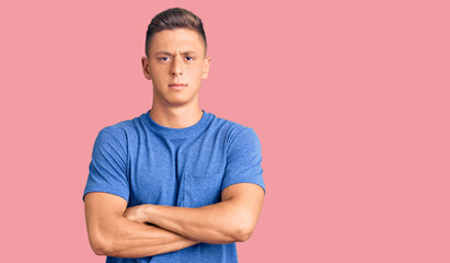 Young handsome hispanic man wearing casual clothes skeptic and nervous, disapproving expression on face with crossed arms. negative person.