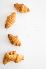 Croissants on white background with empty space.