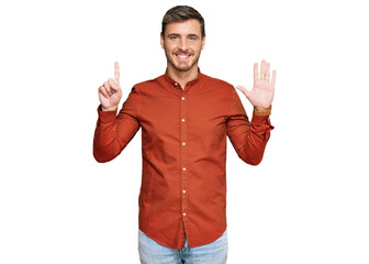 Handsome caucasian man wearing casual clothes showing and pointing up with fingers number six while...