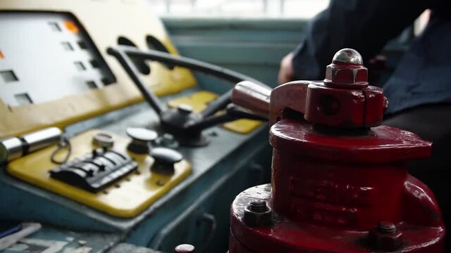 The train driver controls the train. Close-up of the control panel and the hands of a man train driver.