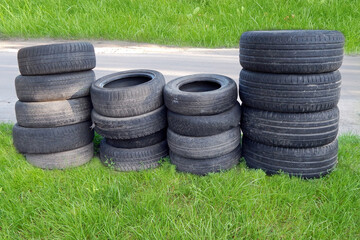 Obraz premium car old tires on green grass horizontal photo