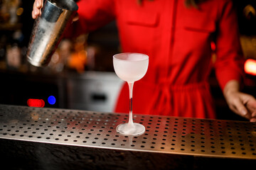 Fototapeta na wymiar beautiful frozen empty transparent glass on long leg stands on the bar