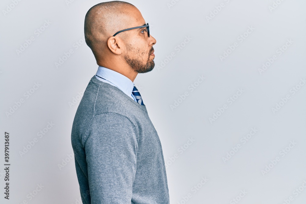 Sticker Hispanic adult man wearing glasses and business style looking to side, relax profile pose with natural face with confident smile.