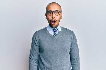 Hispanic adult man wearing glasses and business style afraid and shocked with surprise expression, fear and excited face.