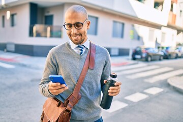 Young african american businessman smiling happy using smartphone at the city.