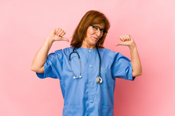 Middle age caucasian nurse woman isolated feels proud and self confident, example to follow.