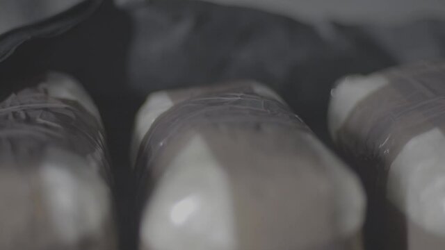 Cocaine Bag in black bag slide shot