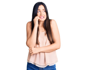 Young beautiful caucasian woman wearing casual clothes looking stressed and nervous with hands on mouth biting nails. anxiety problem.