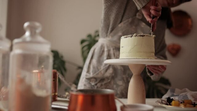 Close up of woman hands making sweet cake with white cream and biscuit. Master class in the kitchen. The process of cooking. Step by step