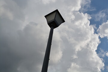 street lamp against blue sky with clouds