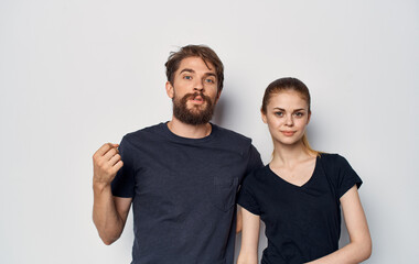 young couple in black t-shirts fun emotions casual clothes studio