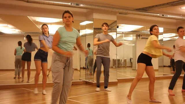 Group of teenage boys and girls enjoying dance class together