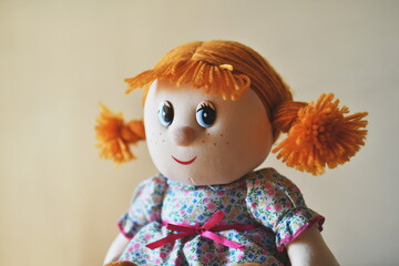 Close up of a doll with a red hair. Selective focus.