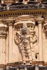 Hampi, Karnataka, India - November 4, 2013: Virupaksha Temple complex. Closeup of 4-armed woman on south side of east Gopuram. 