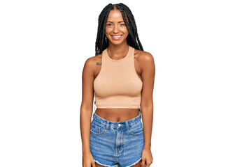 Beautiful hispanic woman wearing casual clothes winking looking at the camera with sexy expression,...