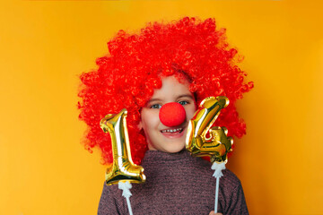 Funny kid girl clown playing at home. 1 April Fool's day concept.