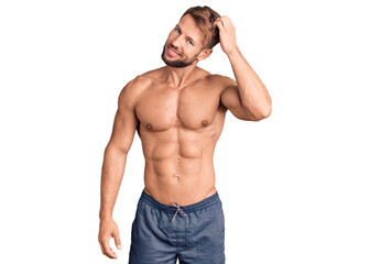 Young caucasian man standing shirtless confuse and wonder about question. uncertain with doubt,...
