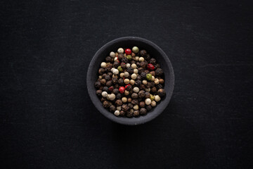 Pepper in bowl on dark background