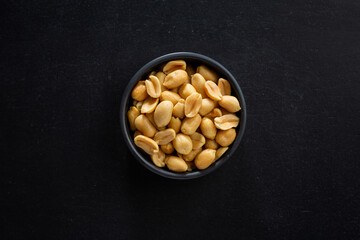 Peanut in bowl on dark background