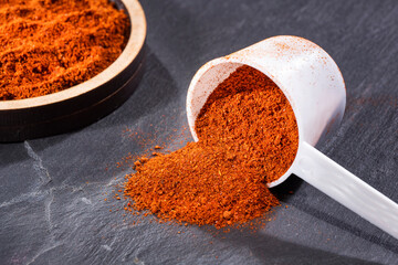 Organic paprika powder in spoon - Capsicum annuum
