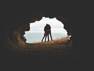 Fototapeta premium Couple in love hugging silhouettes. Emotional cuddle as a symbol of being together no matter what. Text copy