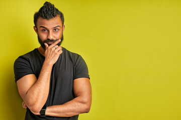 young arabic handsome man confuse and wonder about question, male is uncertain with doubt,...