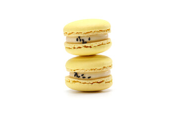 two cake of macaron or macaroon yellow lemon color. Delicious macaroon isolated on white background. French sweet cookie.