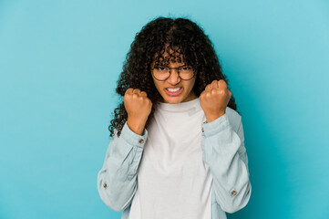 Young african american afro woman isolated upset screaming with tense hands.