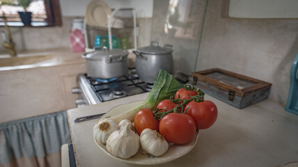 image of a traditional vintage kitchen where we see pots and vegetables for cooking
