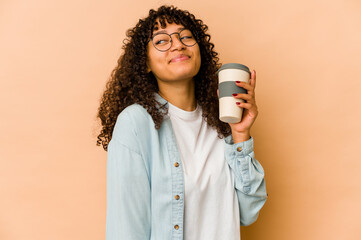 Young african american afro woman holding a takeaway coffee dreaming of achieving goals and purposes
