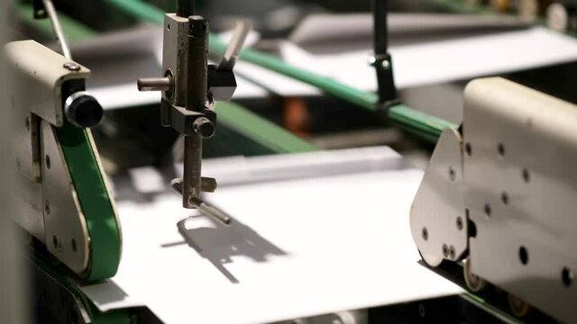 Conveyor line for the production of boxes. Machine carves and bends cardboard boxes from sheets of cardboard. Enterprise for the production package..