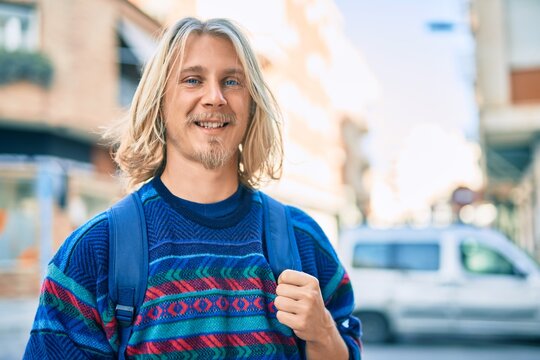 Young scandinavian student man smiling happy standing at the city.