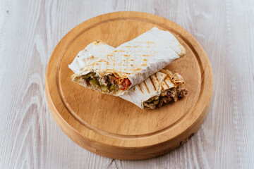 Turkish Shawarma on a wooden Board and light background