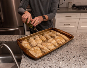 Breaded chicken being finished for cooking