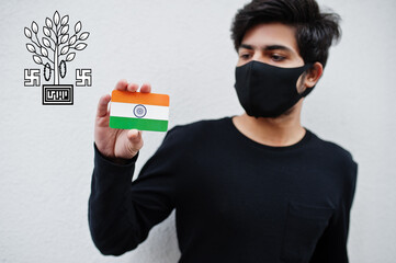 Indian man wear all black and face mask, hold India flag in hand isolated on white background with Bihar state emblem . Coronavirus India states and union territories concept.