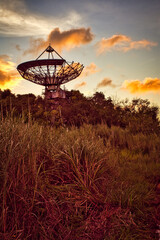 sunset on a satellite dish in a field 